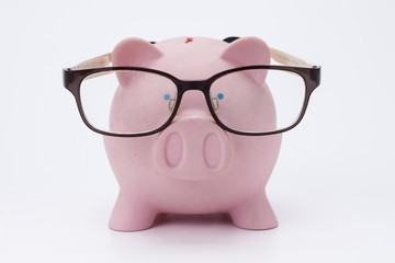 Pink piggy bank with glasses isolated