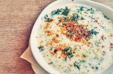 A bowl with summer soup on a wooden table in a restaurant