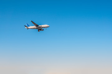 Fototapeta na wymiar Airplane departure flying in a blue sky day