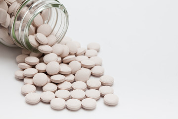 Pills spilling from bottle on isolate 