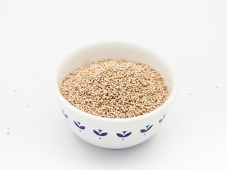 Row sesame seed in white porcelain bowl isolated
