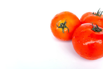 Close up red tomatoes isolated on white background.Tomatoes are vegetables that contain vitamin C and A. And also have anti-oxidants such as lycopene Beta-carotene and phosphorus as well.