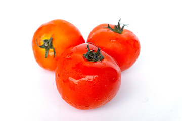 Close up red tomatoes isolated on white background.Tomatoes are vegetables that contain vitamin C and A. And also have anti-oxidants such as lycopene Beta-carotene and phosphorus as well.