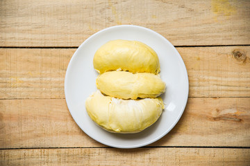 Fresh durian peel tropical fruit summer on white plate and wooden