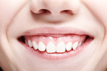 Woman with pink lips and healthy dentes.Girl is smiling.