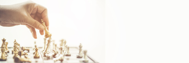 The businessman's hand is picking up chess. Who is the commander To play successfully in the...
