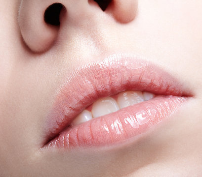 Closeup shot of human female face. Woman with pink plump lips makeup