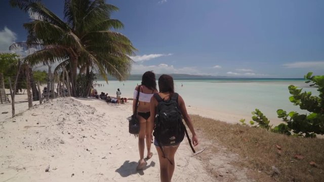 Slow Motion: Two Young Women Walk Along a Sandy Shore - Cayo Arena, Dominican Republic