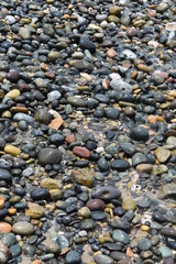 Rocas y piedras lisas a la orilla del mar de día. Texturas y colores.