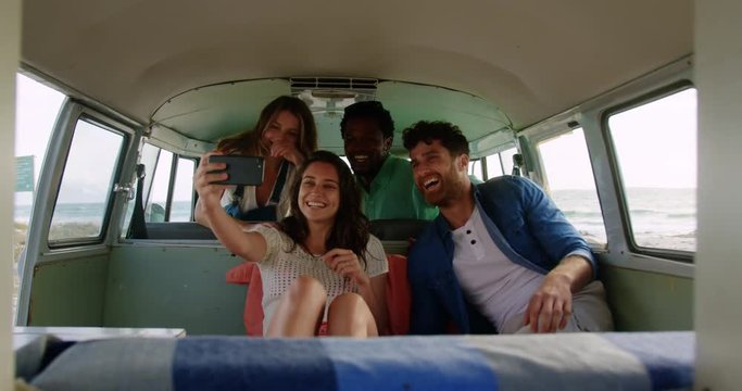 Group of friends taking selfie in camper van 4k
