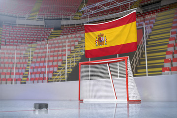 Flag of Spain in hockey arena with puck and net