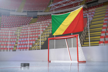 Flag of Republic of the Congo in hockey arena with puck and net