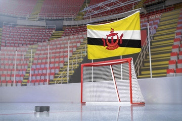 Flag of Brunei in hockey arena with puck and net