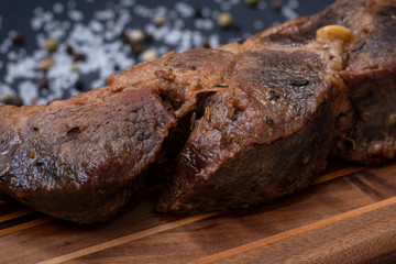 Oven Roasted Pork with spices on wooden cutting board.