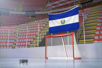 Flag of El Salvador in hockey arena with puck and net