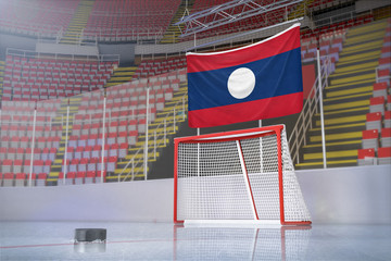 Flag of Laos in hockey arena with puck and net