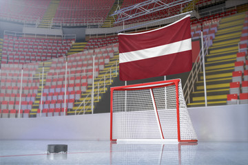 Flag of Latvia in hockey arena with puck and net