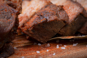 Oven Roasted Pork with spices on wooden cutting board.