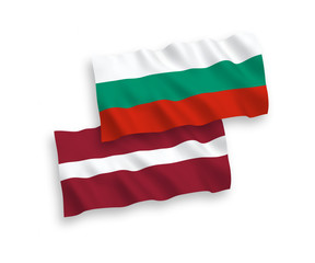 National vector fabric wave flags of Latvia and Bulgaria isolated on white background. 1 to 2 proportion.