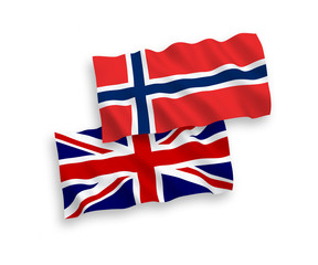 National vector fabric wave flags of Norway and Great Britain isolated on white background. 1 to 2 proportion.