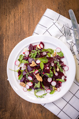 Salad of young beets, mustard leaves, radish nuts and garlic