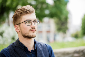 handsome man with a beard and glasses, close-up