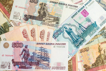 Money. Russian rubles. Notes in denominations of ten, fifty, one hundred, five hundred and a thousand rubles. Cash. Background texture.