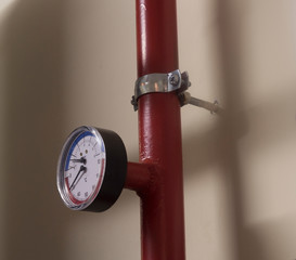 A number of identical manometers stand on plastic pipes with red valves