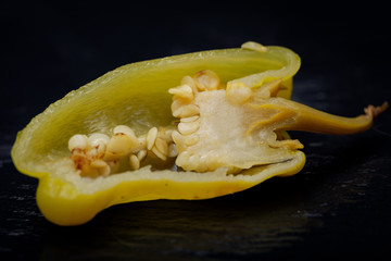Pickled Golden Greek Peppers, Pepperoncini or Friggitelli (sweet Italian chili pepper) on natural stone background. Capsicum annuum.