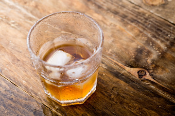 Top view of whiskey with ice in a glass 