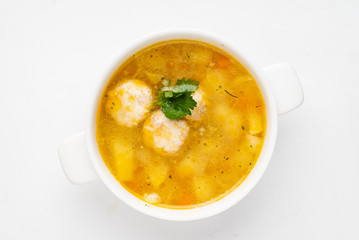 soup with meatballs on the white background, top view