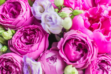 Fototapeta na wymiar Texture background of flowers, peonies, roses. Arrangement of flowers in a hat box. Bouquet of peonies, eustoma, spray rose in a pink box with an oasis on a white background