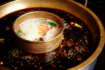 Chinese hot pot dish, spicy and white soup