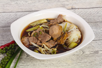 Thai style soup with meat and mushrooms