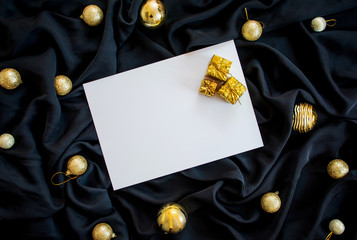 Black color decorated silk background with gift boxes and golden balls, season greetings background