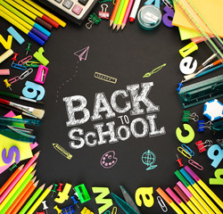 Back to school background office stationery items on blackboard 