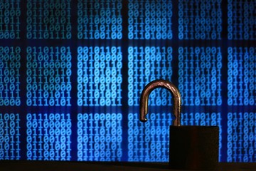 opened padlock in front of binary code blocks background. cyberspace computer security breached....