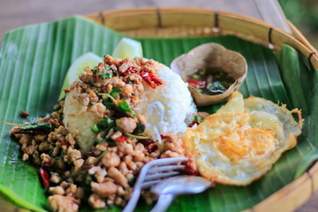 Fried Stir Basil with Minced pork On banana leaves with nature.