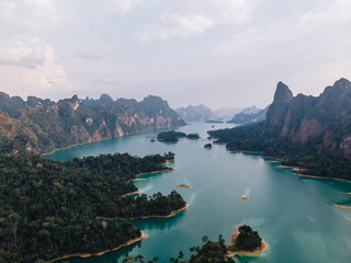 Aerial view of Cheo Lan lake in Thailand. Green mountains and dramatic sky. Travel Thailand