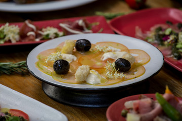 Fresh healthy tomato carpaccio with balsamic vinegar, mozzarella and olives. Healthy eating