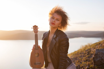 full of joyful feeling satisfaction for beautiful blonde young woman playing alone the acoustic...