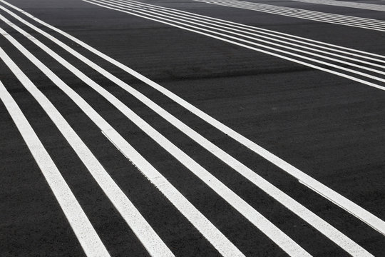 Striped white lines on the ground. © Tata Chen