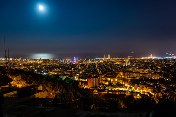 Barcelona skyline panorama at night from Turo Rovira, Catalonia, Spain.