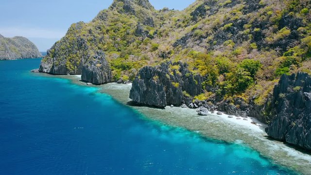 Matinloc island, El Nido, Palawan, Philippines. Aerial view of cute small beaches, crystal clear water, sharp cliffs and coral reefs. Unique spot, top touristic destination and must-see place