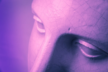 Closeup face gypsum copy antique sculpture with craquelure. Pink purple vintage filter effect. Eyes.
