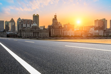 Fototapeta na wymiar Shanghai bund city skyline and empty asphalt highway at sunset