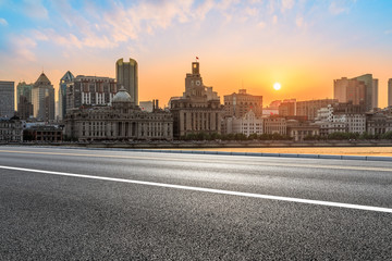 Fototapeta na wymiar Shanghai bund city skyline and empty asphalt highway at sunset