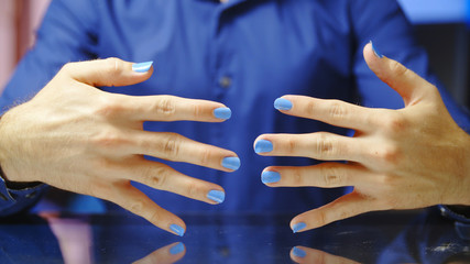 Male person with blue polished fingernails