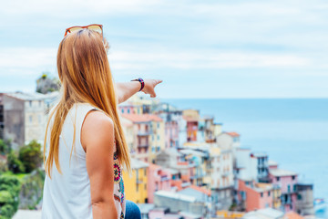 Fototapeta na wymiar Young woman traveling through Europe, Cinque Terre, Italy
