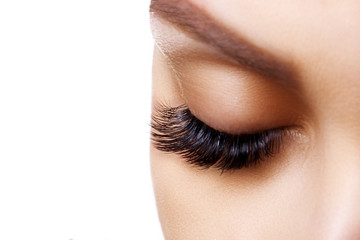 Fototapeta premium Eyelash Extension Procedure. Woman Eye with Long Blue Eyelashes. Ombre effect. Close up, selective focus.